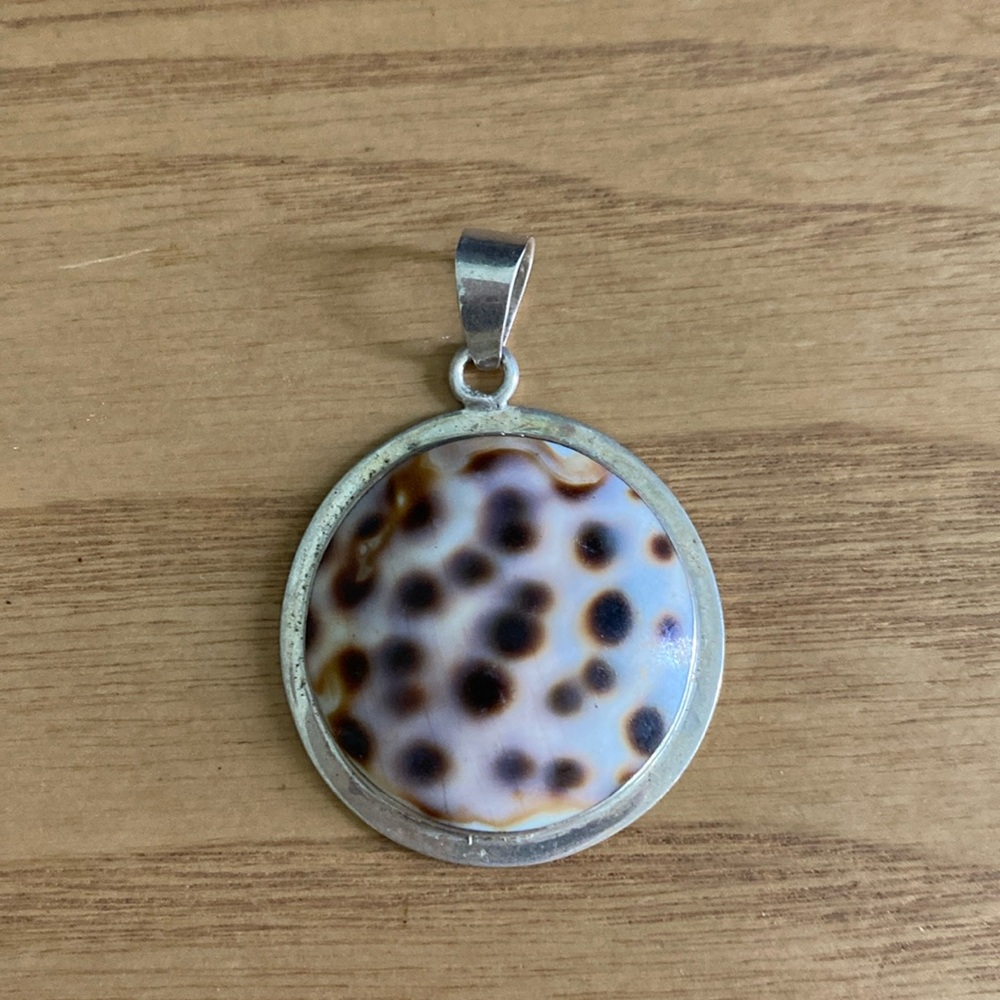 Tiger cowrie shell and sterling silver pendant.